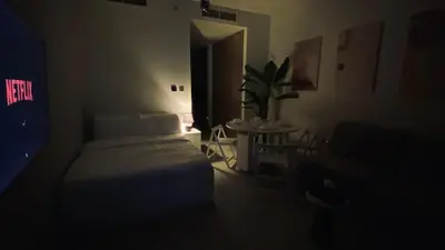 a dark room with a bed and a potted plant at Sky Burj Khalifa View in Dubai