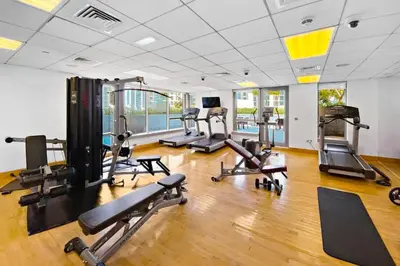 a gym with several treadmills and exercise bikes at Lux Burj and Fountain views Steps from Dubai Mall in Dubai