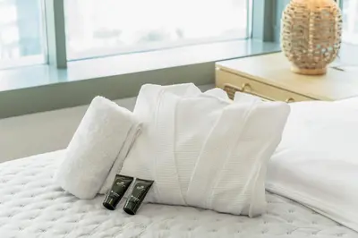 a white bed with two white pillows on it at Lux Burj and Fountain views Steps from Dubai Mall in Dubai
