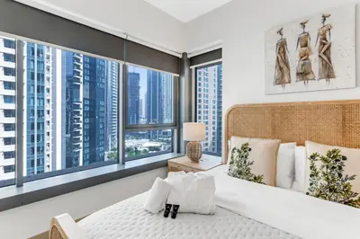 a bedroom with a large bed and large windows at Lux Burj and Fountain views Steps from Dubai Mall in Dubai