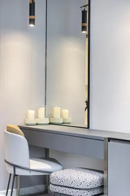 a dressing table with a mirror and a chair at Chic Studio 5 Min Walk to Dubai Mall & Burj in Dubai
