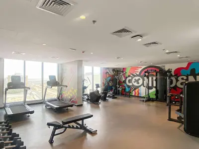 a gym with exercise equipment in a building at Modern Studio in Al Furjan with pool and gym in Dubai