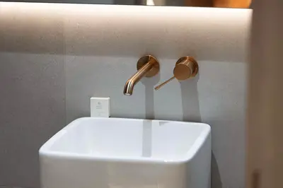 a bathroom sink with a faucet on the wall at Modern 1-Bedroom Apartment with Luxurious Amenities in JVC in Dubai