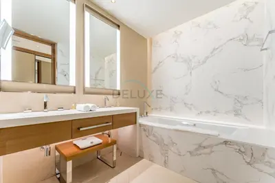 a bathroom with a tub and a sink at Overlooking Burj Khalifa and Fountain Views from Living to Bedrooms, The Address Residences Dubai Opera Tower 2, Downtown Dubai by Deluxe Holiday Homes in Dubai