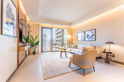 a living room with a couch and a table at Overlooking Burj Khalifa and Fountain Views from Living to Bedrooms, The Address Residences Dubai Opera Tower 2, Downtown Dubai by Deluxe Holiday Homes in Dubai