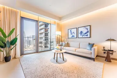 a living room with a couch and a table at Overlooking Burj Khalifa and Fountain Views from Living to Bedrooms, The Address Residences Dubai Opera Tower 2, Downtown Dubai by Deluxe Holiday Homes in Dubai