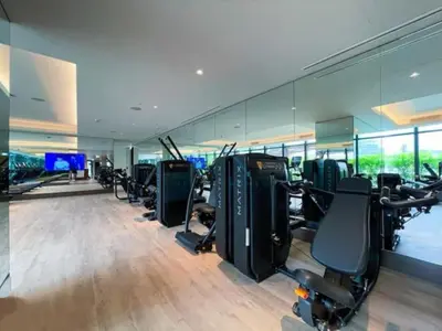 a gym with a row of treadmills and exercise bikes at Overlooking Burj Khalifa and Fountain Views from Living to Bedrooms, The Address Residences Dubai Opera Tower 2, Downtown Dubai by Deluxe Holiday Homes in Dubai
