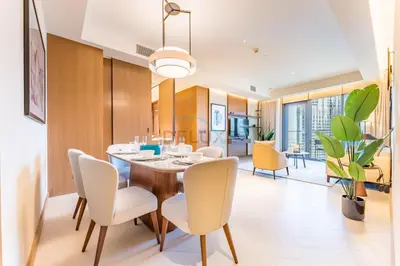 a dining room with a table and chairs at Overlooking Burj Khalifa and Fountain Views from Living to Bedrooms, The Address Residences Dubai Opera Tower 2, Downtown Dubai by Deluxe Holiday Homes in Dubai