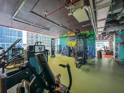 a gym with cardio equipment in a large room at MBL Royal, JLT- Two Bedroom with Lake View in Dubai