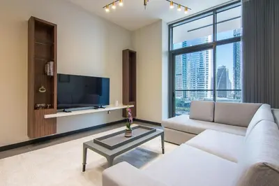 a living room with a couch and a tv at MBL Royal, JLT- Two Bedroom with Lake View in Dubai