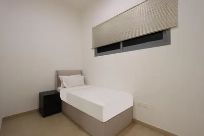 a white room with a bed and a window at Livbnb-Tranquil Family Home, 4BR with Maid's Room in Dubai