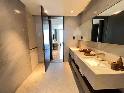 a bathroom with two sinks and a large mirror at Daniels 4BR at Five Palm With Private Pool in Dubai