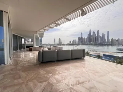 a living room with a couch and a view of a city at Daniels 4BR at Five Palm With Private Pool in Dubai