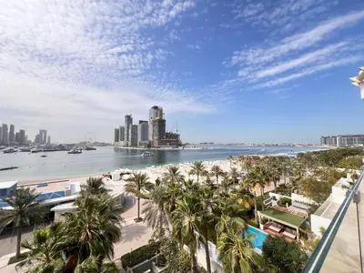 a view of a beach with palm trees and a city at Daniels 4BR at Five Palm With Private Pool in Dubai