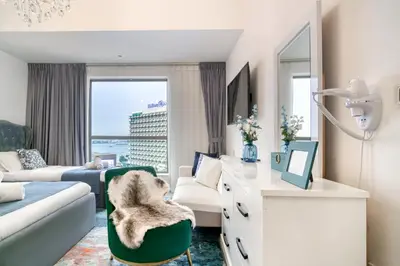 a living room with a couch and a desk at THE JBR Grand Luxury Sea View 4 BEDROOM in Dubai