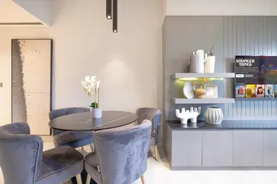 a dining room with a table and chairs at Upscale 2BR in Lively Building in Dubai