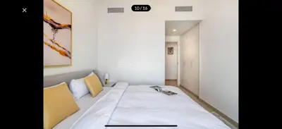 a small bedroom with a bed with a white bedspread at Downtown holiday home in Dubai