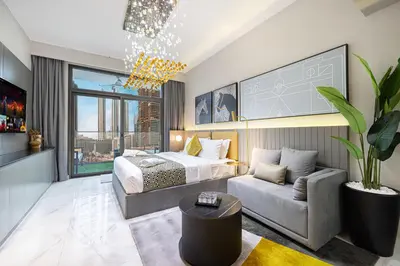 a bedroom with a bed and a couch at Cozy Studio Steps from Dubai Mall & Burj Khalifa in Dubai