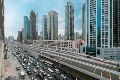 a busy highway in a large city with cars at Cozy Studio Steps from Dubai Mall & Burj Khalifa in Dubai