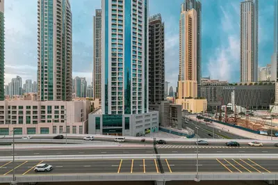a highway in a large city with tall buildings at Cozy Studio Steps from Dubai Mall & Burj Khalifa in Dubai