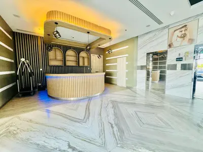 a lobby with a large marble floor and a bar at Bab al qarya in Dubai