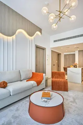 a living room with a couch and a table at Luxury 1BR Haven Chic & Cozy Stay in JVC in Dubai