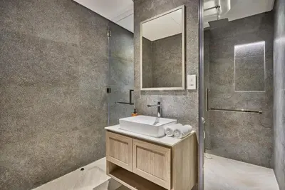 a bathroom with a sink and a mirror at Luxury 1BR Haven Chic & Cozy Stay in JVC in Dubai