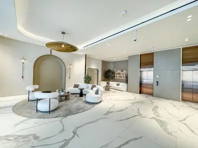 a large living room with a marble floor at Luxury 1BR Haven Chic & Cozy Stay in JVC in Dubai