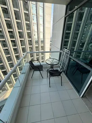 a balcony with two chairs and a table at Marina Haven with Jacuzzi in Dubai