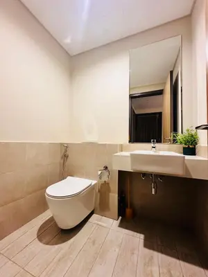 a bathroom with a toilet and a sink at Airvistas retreat at wasl one residence in Dubai