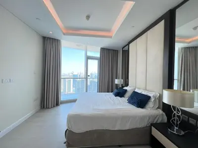 a bedroom with a large bed and a large window at The Burj Panarama in Dubai