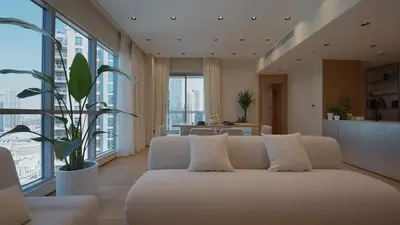 a living room with a white couch and some windows at Mori - luxury Burj full view in Dubai