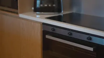a kitchen with a microwave and a black oven at Mori - luxury Burj full view in Dubai