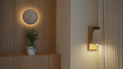 a plant on a shelf in a room with a light at Mori - luxury Burj full view in Dubai