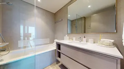 a bathroom with a sink and a tub and a mirror at Best 2 bedroom Direct Burj Khalifa Downtown View in Dubai