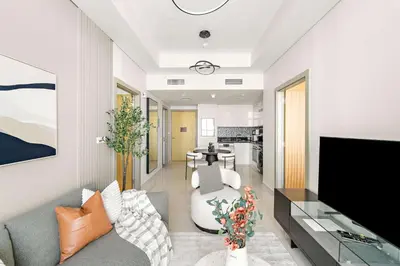a living room with a couch and a tv at Silkhaus Luxury 2BDR at Aykon City in Business Bay in Dubai