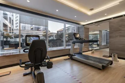 a gym with a treadmill and two exercise bikes at Cozy and elegant Studio in Business Bay in Dubai