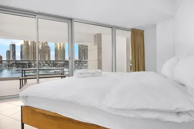 a bedroom with a large white bed and a large window at FIRST CLASS 1BR Inviting Marina Views in Dubai