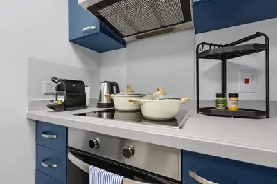a kitchen with two pots sitting on a stove at FIRST CLASS 1BR Inviting Marina Views in Dubai