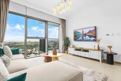 a living room with a tv and large windows at Elegant 1BR in Heart of Dubai, Walk to Top Malls in Dubai