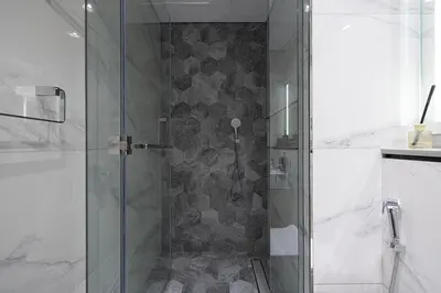 a shower with a glass door in a bathroom at Luxury Studio Near Dubai Mall few mints walk in Dubai