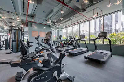 a gym with rows of cardio bikes and treadmills at Luxury Studio Near Dubai Mall few mints walk in Dubai