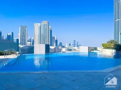 a large swimming pool on top of a city skyline at Elegant 2B at Boulevard Point Burj & Fountain View in Dubai