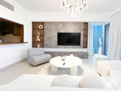 a living room with a white couch and a table at Elegant 2B at Boulevard Point Burj & Fountain View in Dubai