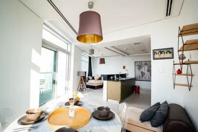 a living room with a table and a couch at The Lofts West Downtown - 2 Minutes Walk to Burj Khalifa-Dubai Mall 1BDR in Dubai