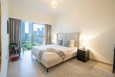 a hotel room with a bed and a large window at Central Park Tower DIFC - 10 Minutes Walk to Metro - Spacious 1BDR in Dubai