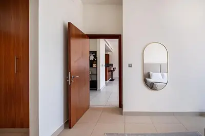 a hallway with a mirror on the wall at Central Park Tower DIFC - 10 Minutes Walk to Metro - Spacious 1BDR in Dubai