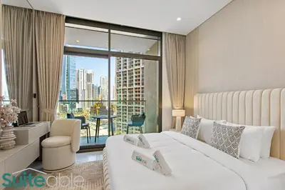 a hotel room with a bed and a large window at Luxury One Bedroom with Burj Khalifa View in Dubai