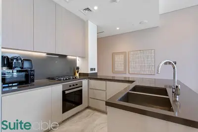 a kitchen with a sink and a microwave at Luxury One Bedroom with Burj Khalifa View in Dubai