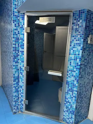 a bathroom with blue tiled walls and a toilet at Marina Diamond 2 - Very Close to Metro - Cozy in Dubai